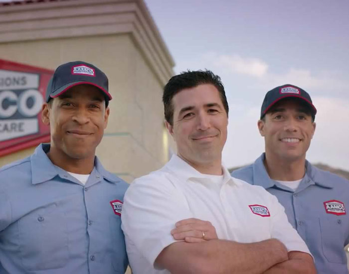 AAMCO servicemen smiling